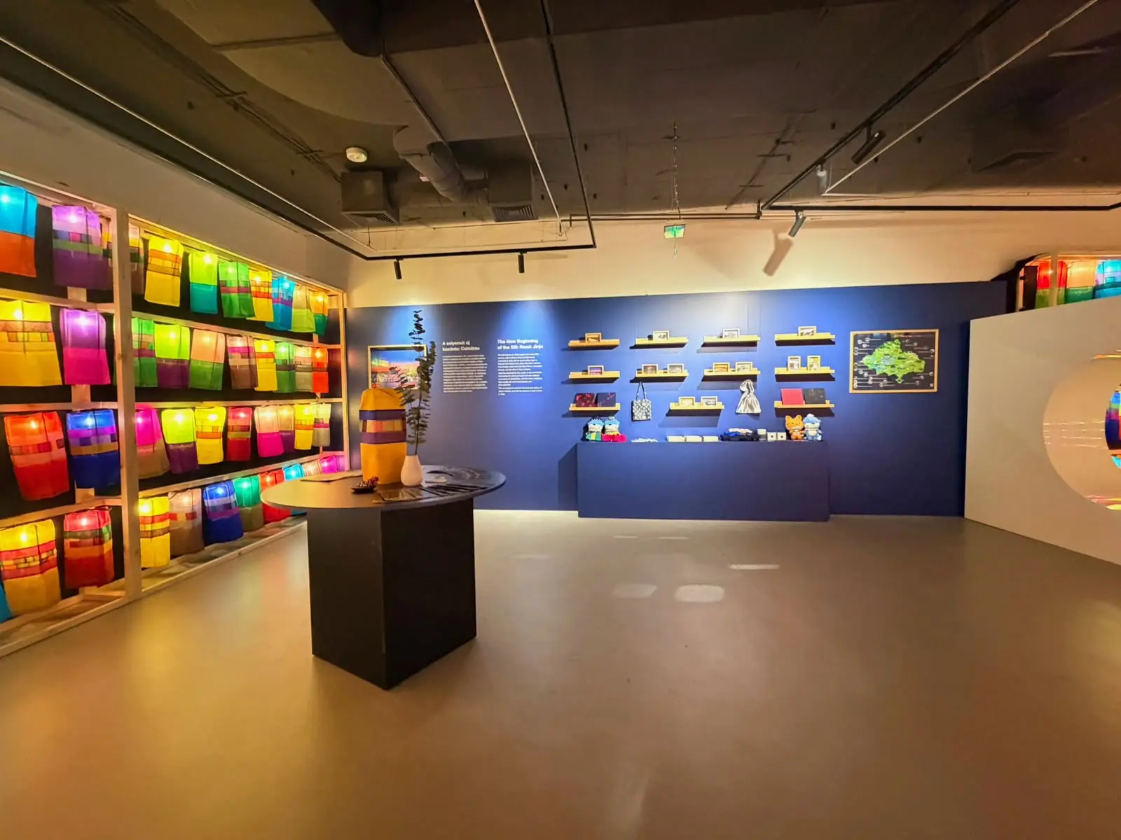 Lit lantern shelving and blue display wall
